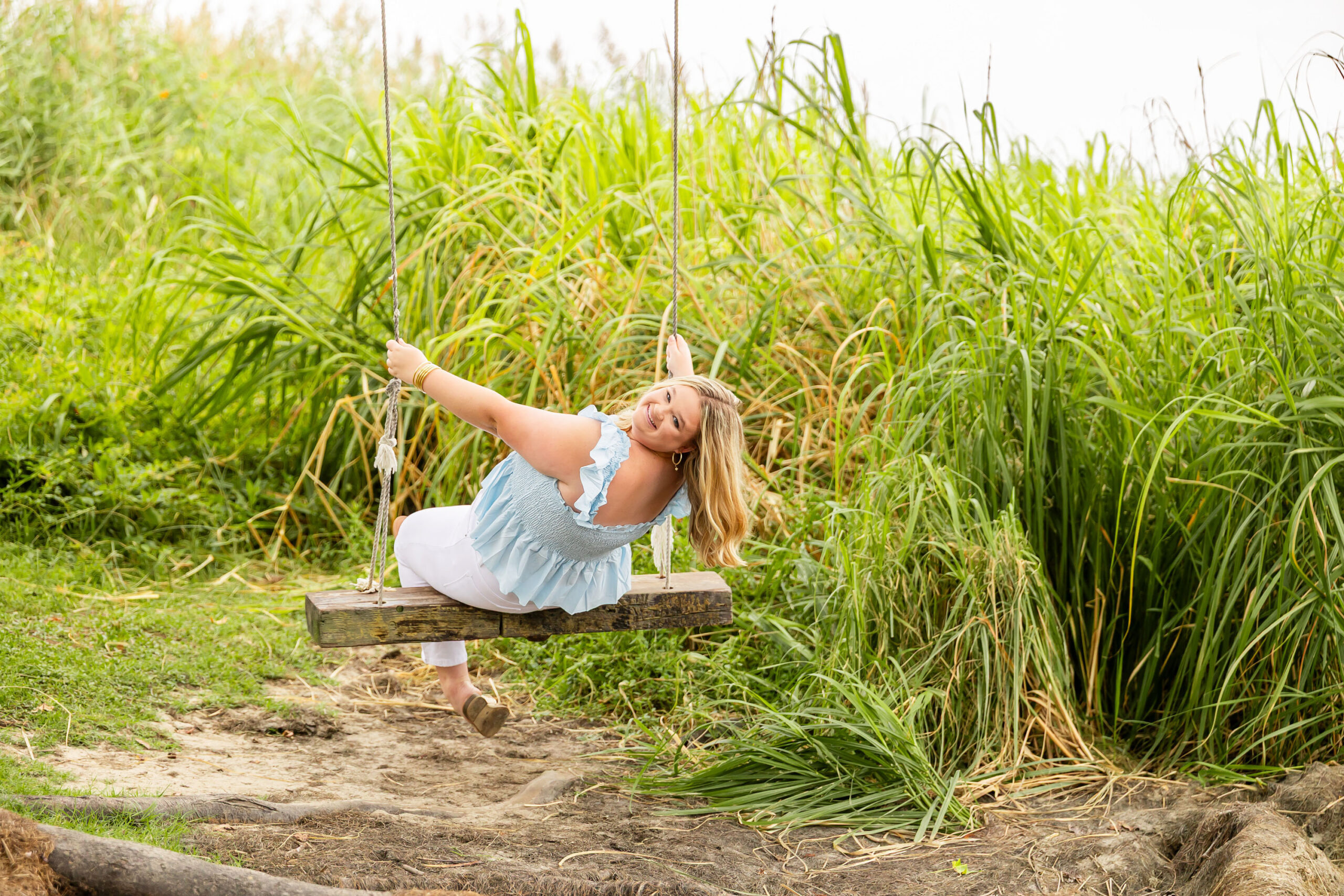 Soft, natural portrait of Mattison with moody skies and the ocean in the background during her OBX senior session.