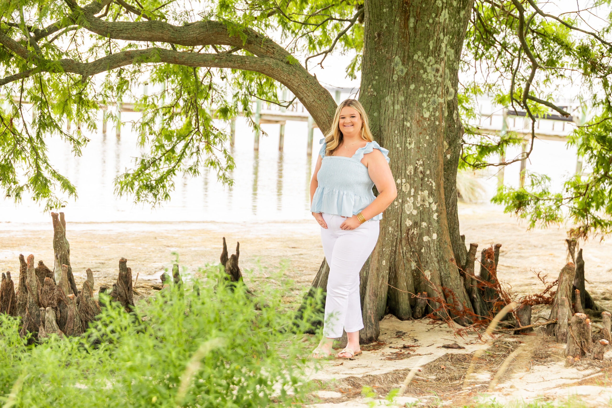 Soft, natural portrait of Mattison with moody skies and the ocean in the background during her OBX senior session.