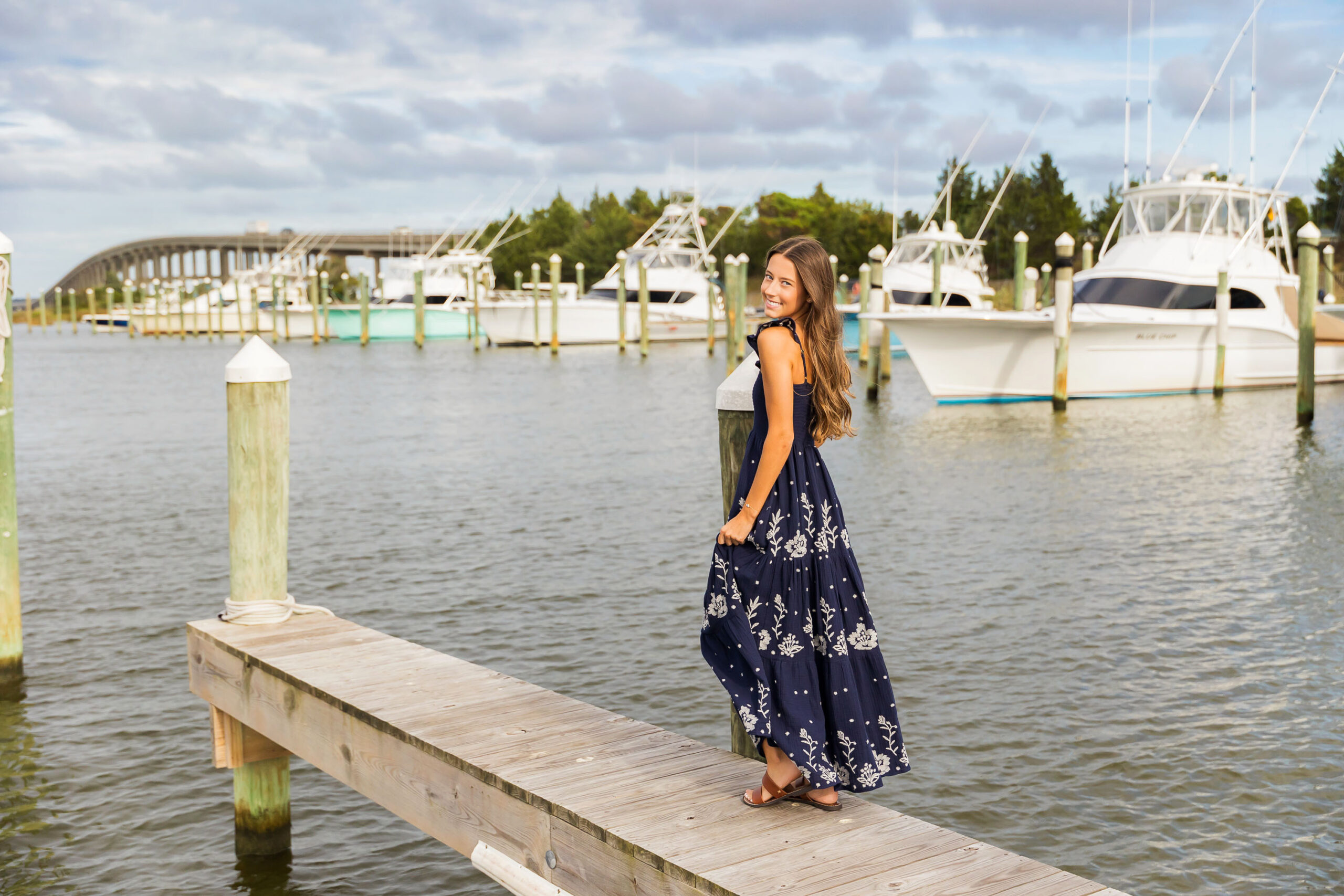 Senior girl on docks at Pirates Cove Marina in Manteo NC