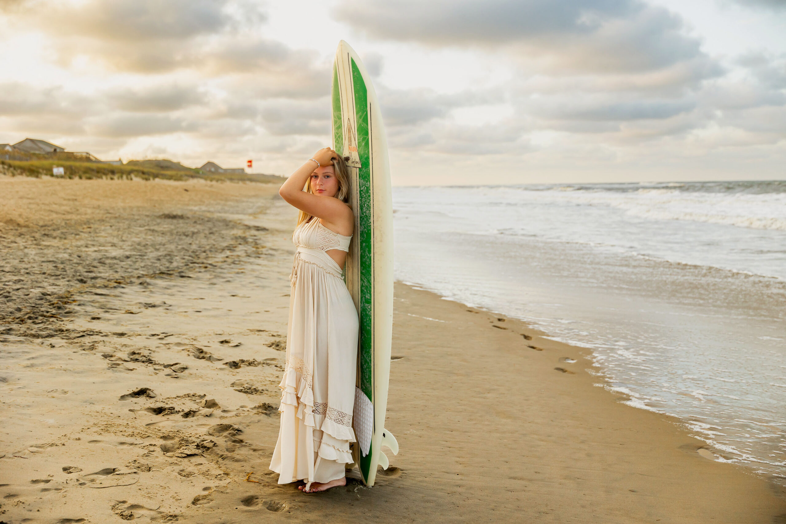 Senior portraits with surfboard on the Outer Banks beach