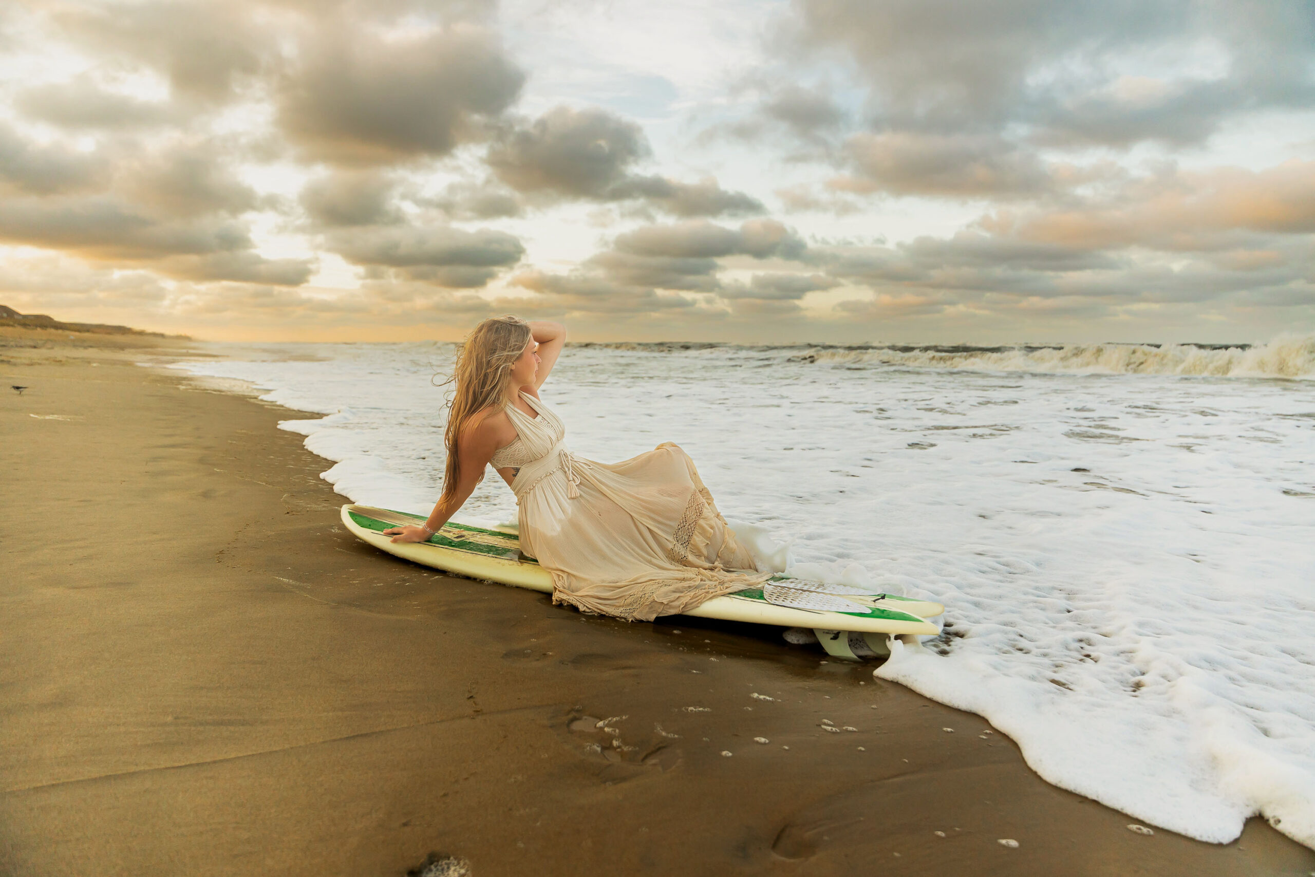 Senior portraits with surfboard on the Outer Banks beach