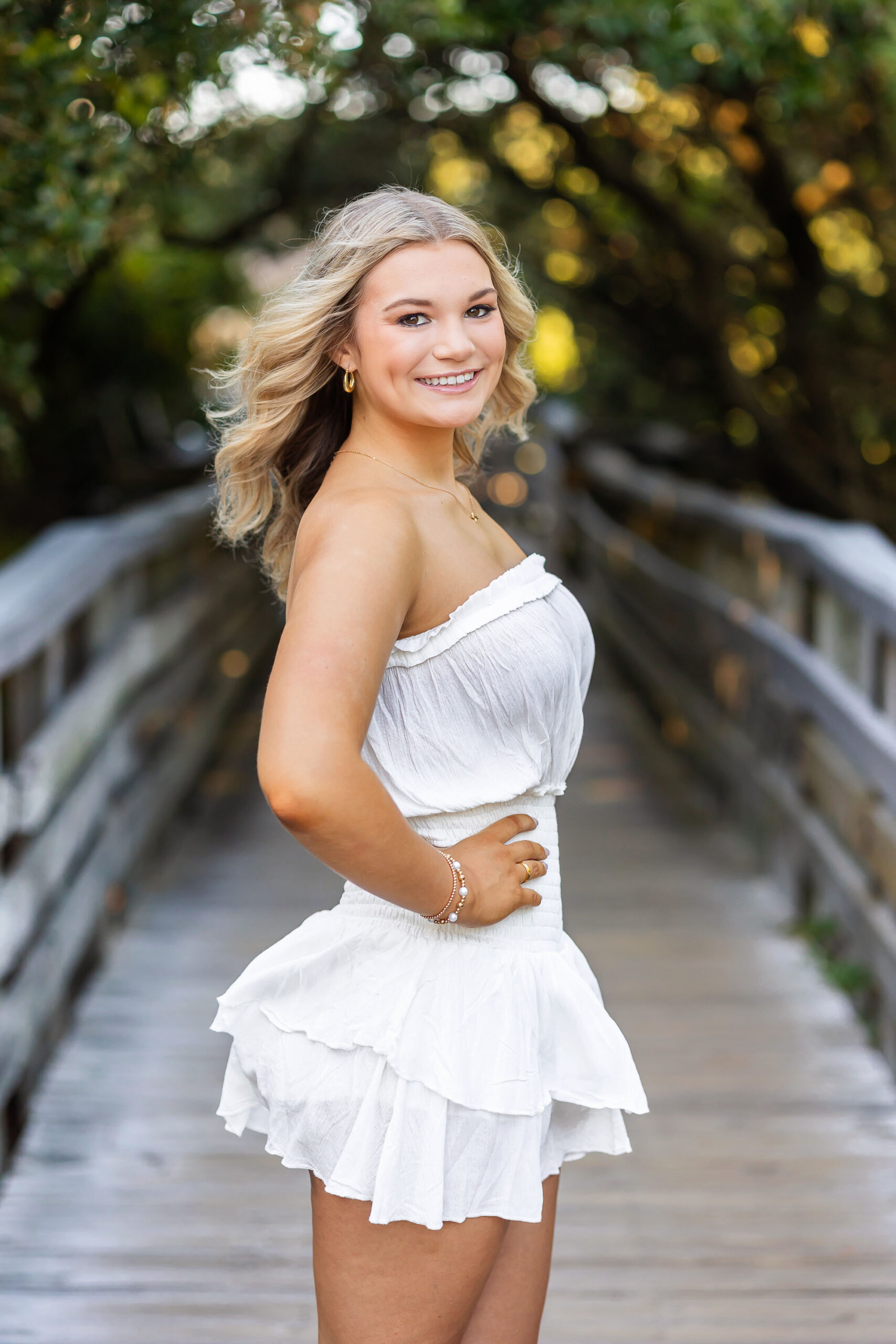 Senior girl standing on boardwalk at Jockey’s Ridge in Nags Head for Outer Banks senior portraits