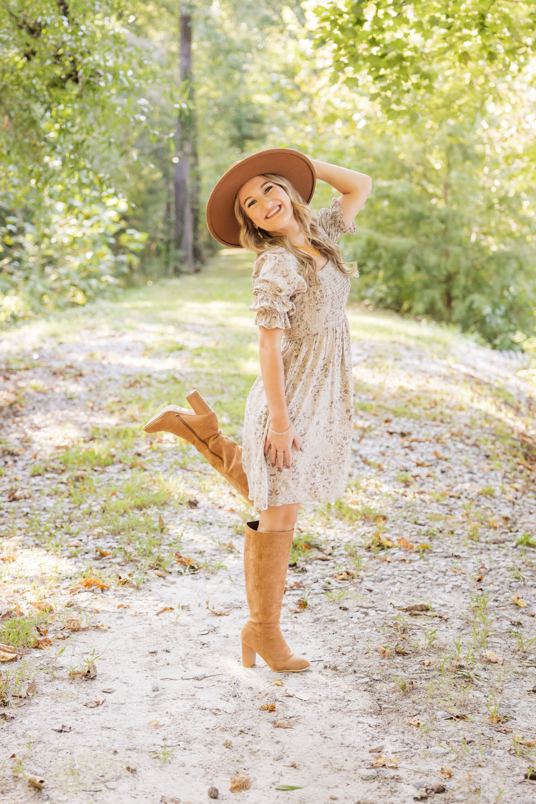 Senior girl njoying her fall senior session in Eastern North Carolina with golden leaves in the background.