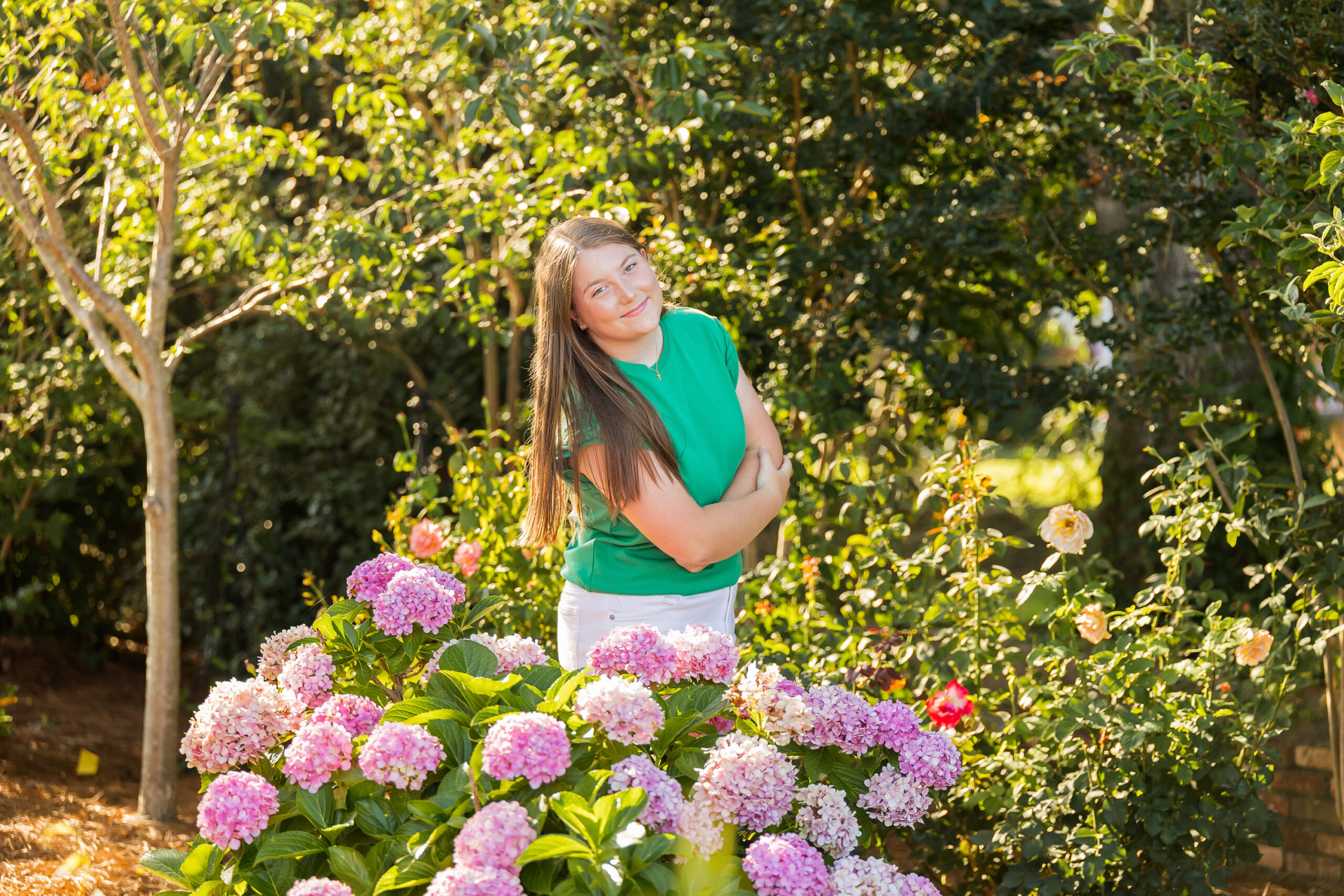 Downtown Edenton senior portraits of Emily from Currituck High School, surrounded by bright summer flowers during her June photo session.