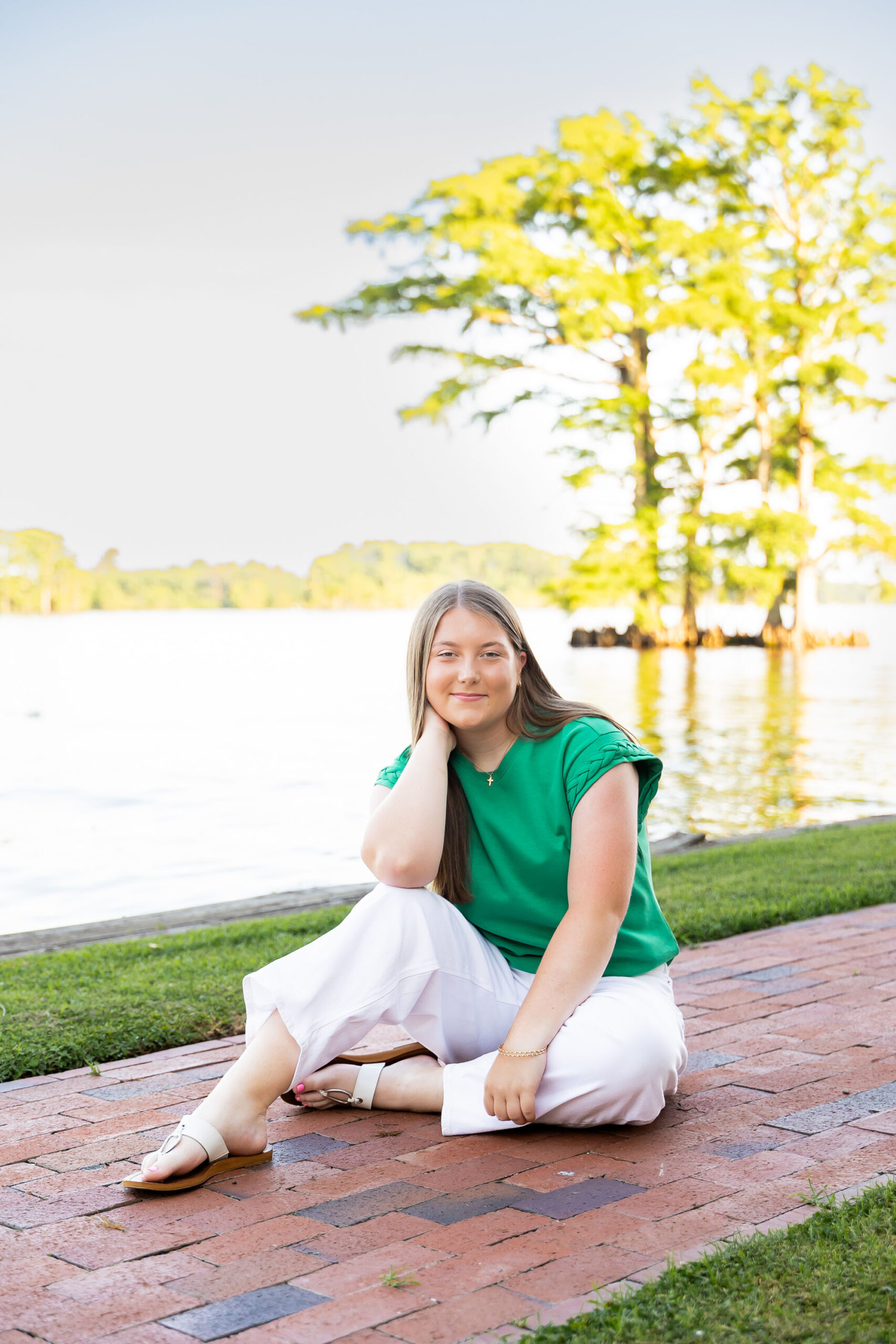 Downtown Edenton senior portraits of Emily from Currituck High School, surrounded by bright summer flowers during her June photo session.