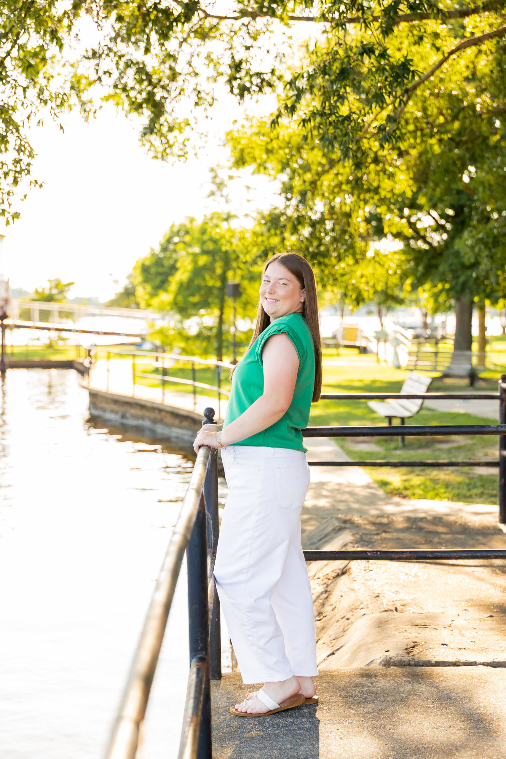 Downtown Edenton senior portraits of Emily from Currituck High School, surrounded by bright summer flowers during her June photo session.