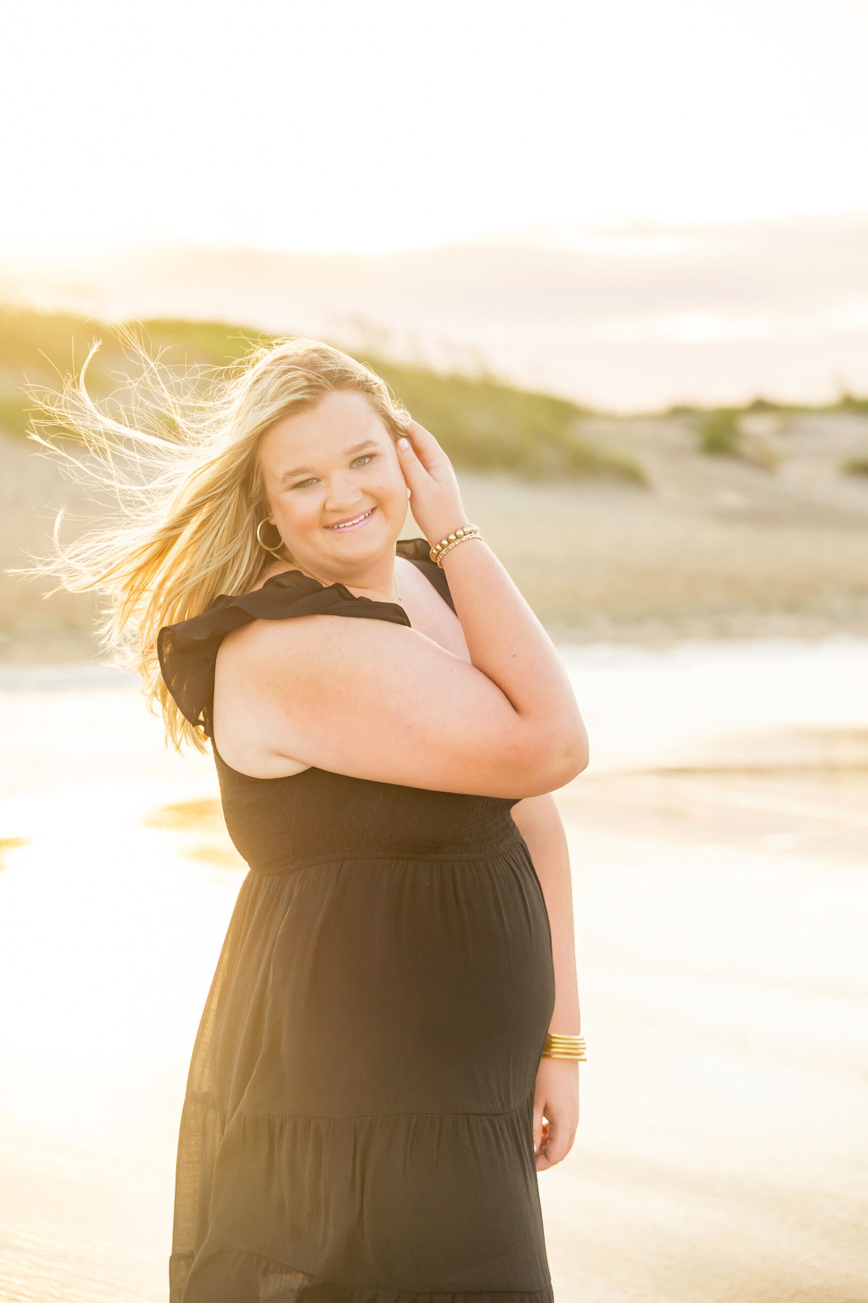 Soft, natural portrait of Mattison with moody skies and the ocean in the background during her OBX senior session.