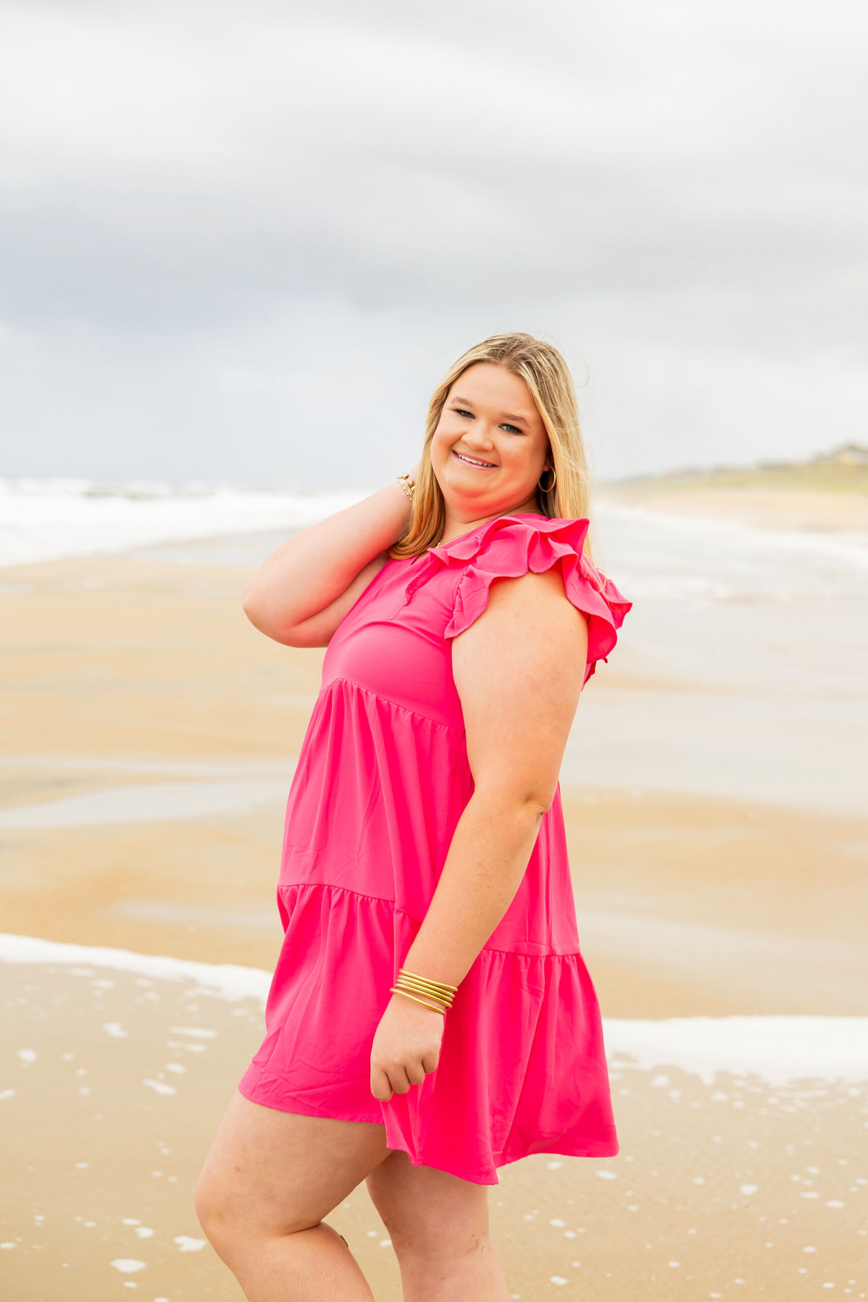 Soft, natural portrait of Mattison with moody skies and the ocean in the background during her OBX senior session.
