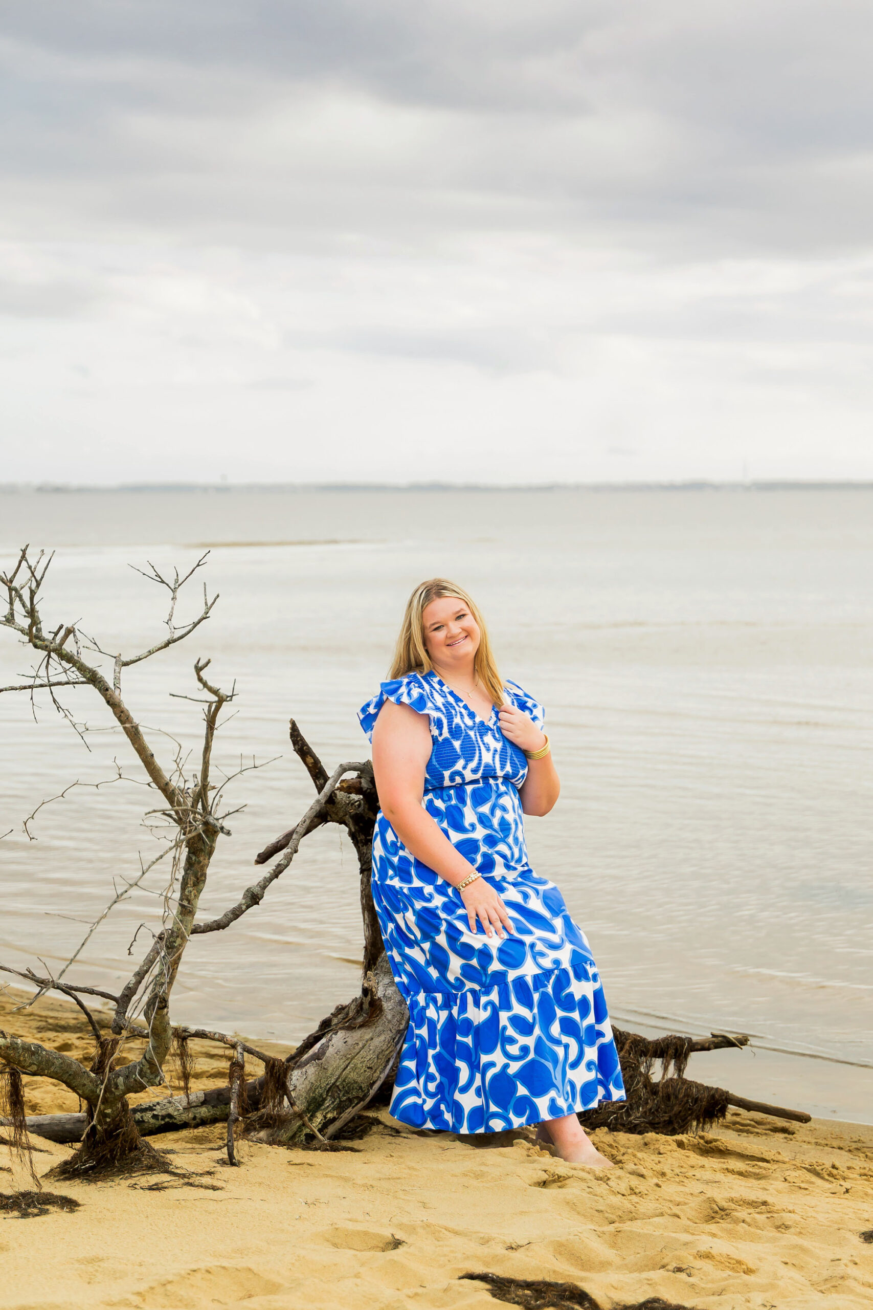 Soft, natural portrait of Mattison with moody skies and the ocean in the background during her OBX senior session.