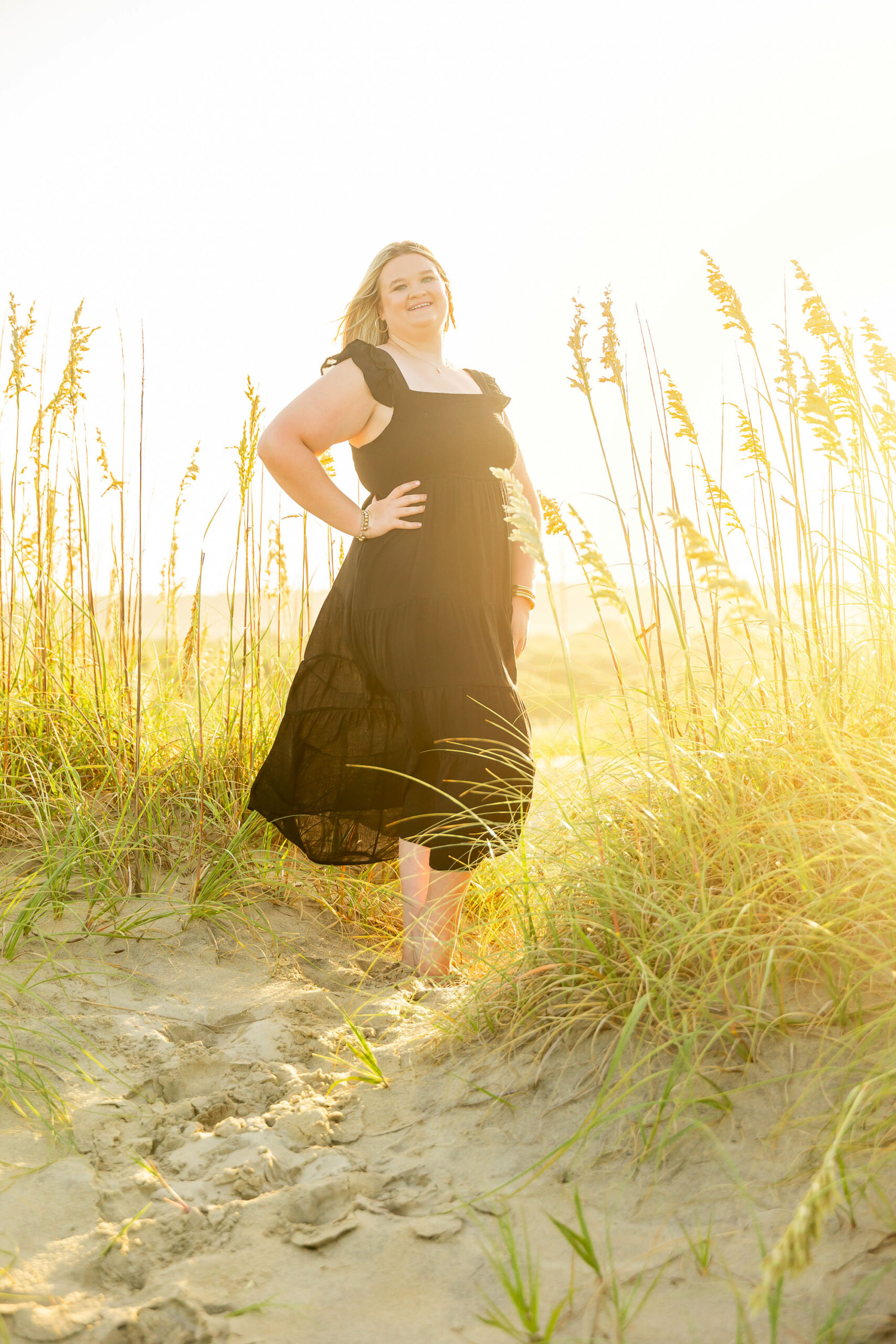Soft, natural portrait of Mattison with moody skies and the ocean in the background during her OBX senior session.
