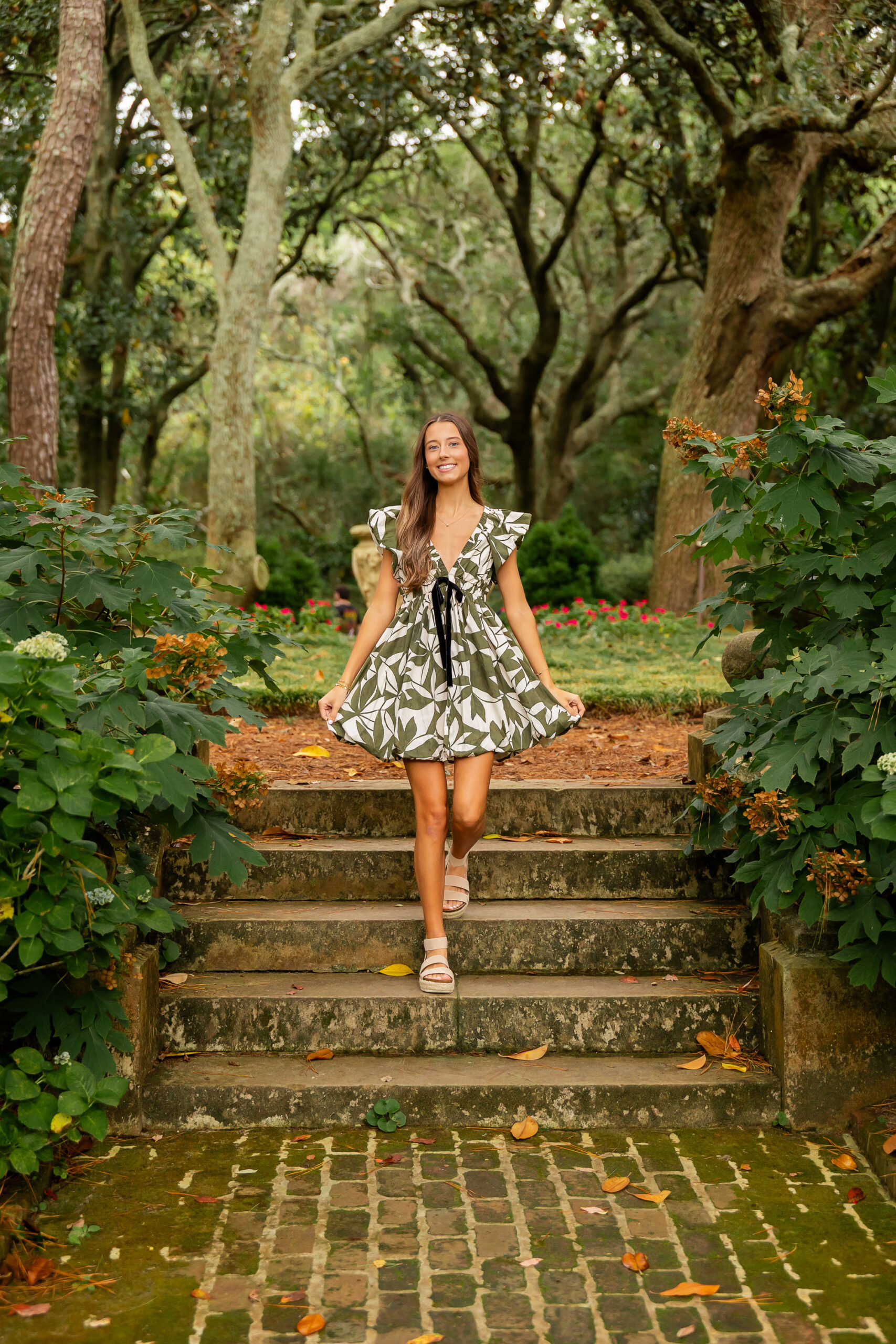 Senior girl in green dress at Elizabethan Gardens in Manteo North Carolina