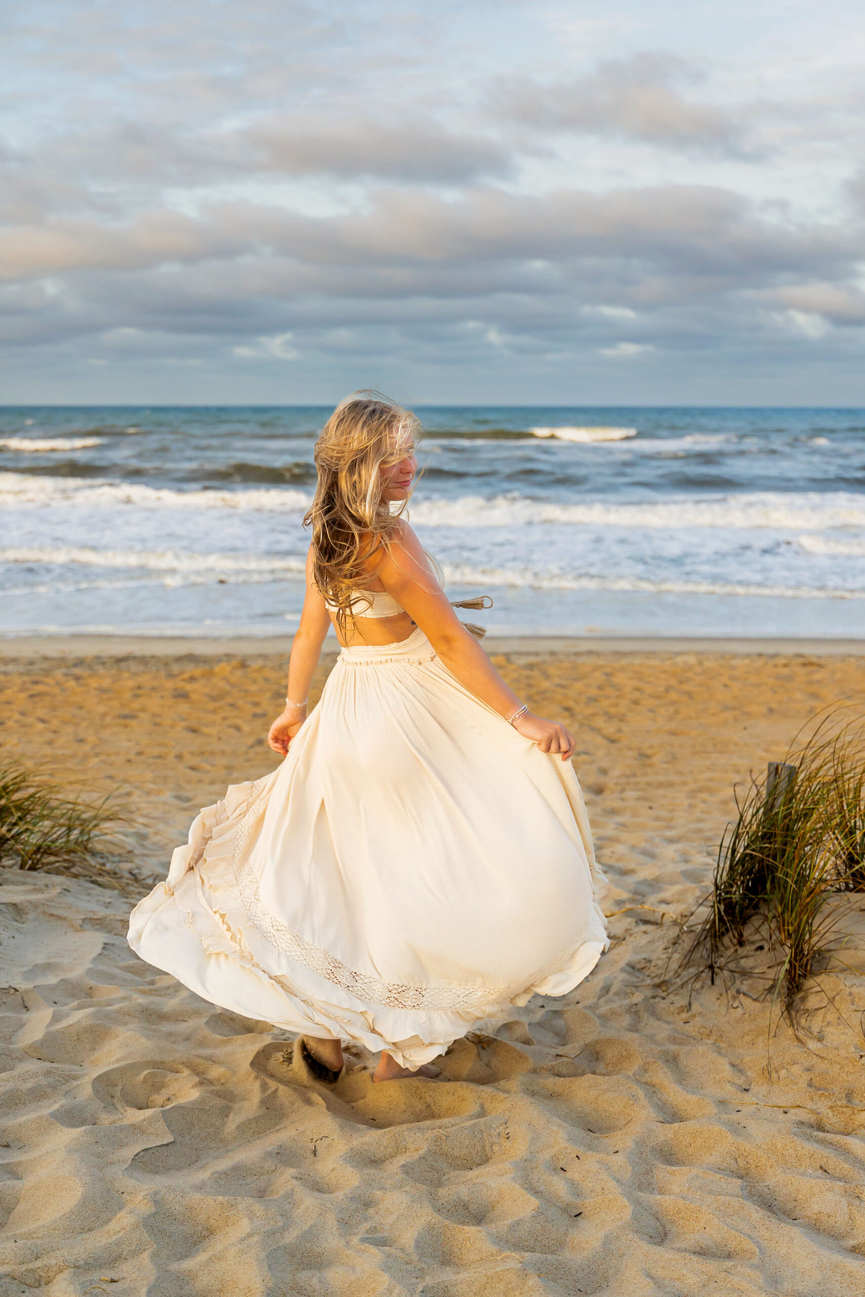 Senior girl beach photos in the Outer Banks with ocean waves