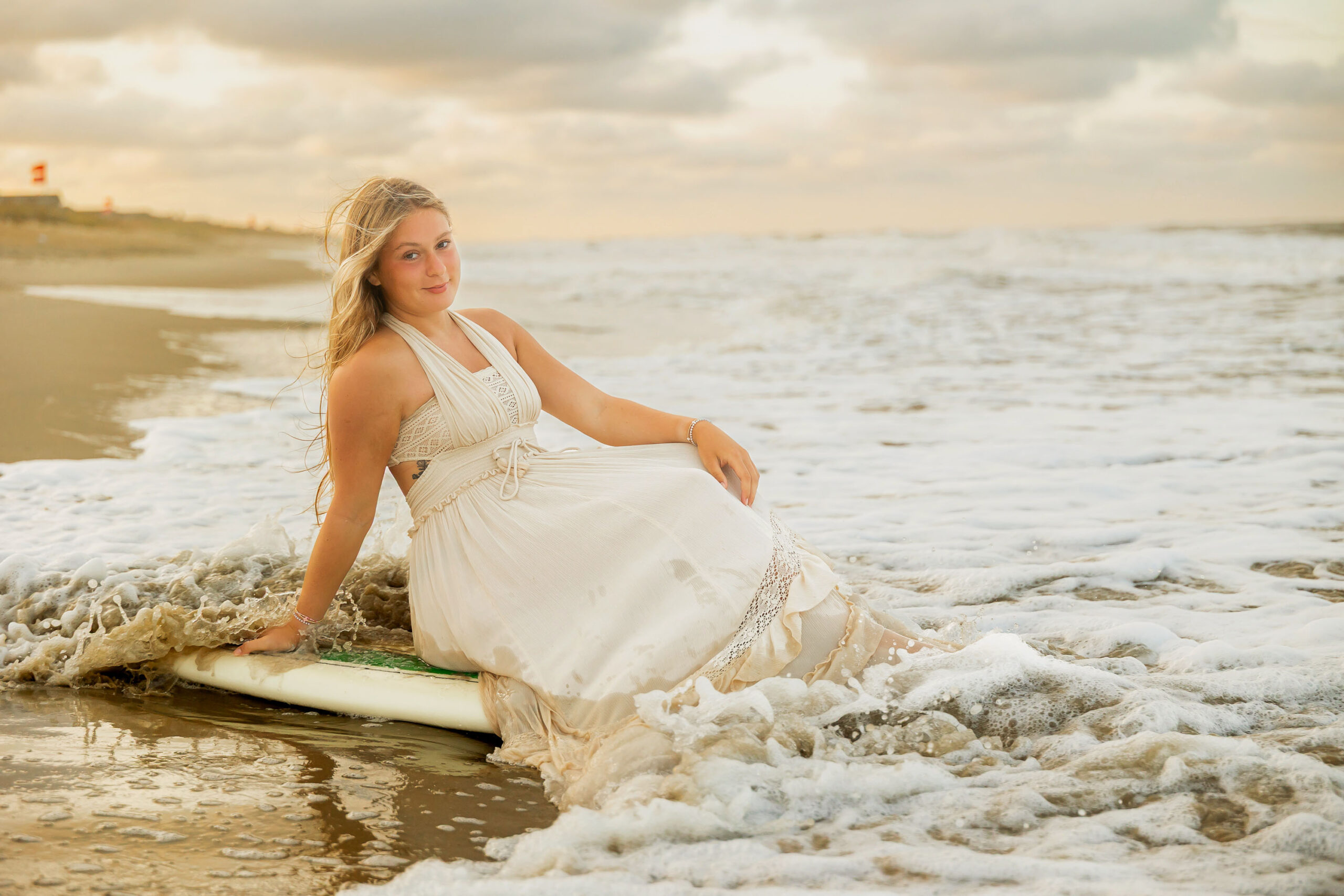 Senior portraits with surfboard on the Outer Banks beach
